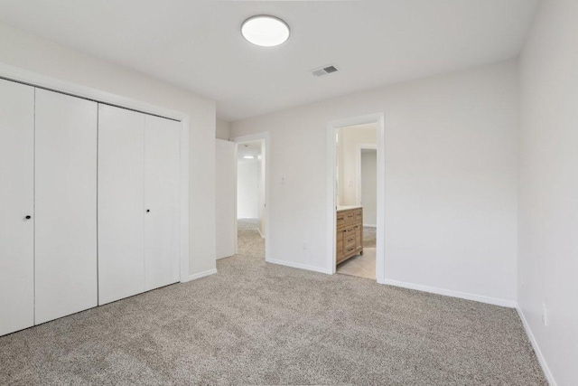 6029 Mount Bonnell Cv, Austin, TX 78731 - unfurnished bedroom featuring light carpet, a closet, and ensuite bathroom
