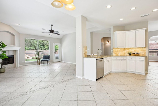 1252 Fall Creek Loop, Cedar Park, TX 78613 - kitchen featuring dishwasher, arched walkways, backsplash, light stone counters, and ceiling fan