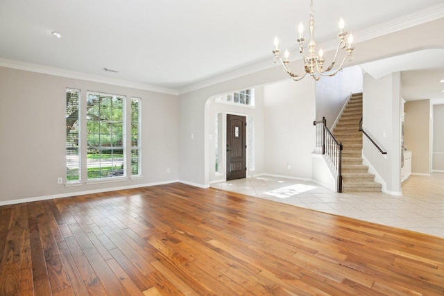 1252 Fall Creek Loop, Cedar Park, TX 78613 - entrance foyer featuring wood finished floors, a chandelier, arched walkways, baseboards, and ornamental molding