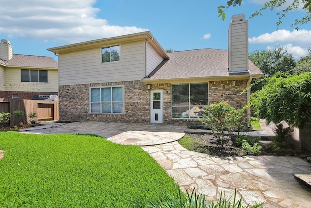 1252 Fall Creek Loop, Cedar Park, TX 78613 - back of house featuring a patio area, brick siding, and a chimney