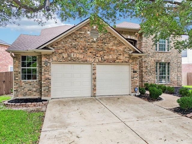 1252 Fall Creek Loop, Cedar Park, TX 78613 - traditional home featuring an attached garage, driveway, brick siding, and a shingled roof