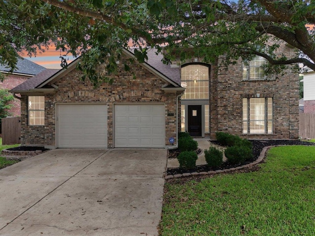 1252 Fall Creek Loop, Cedar Park, TX 78613 - view of front facade featuring an attached garage, driveway, brick siding, and a shingled roof