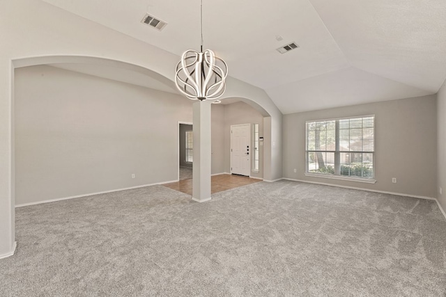 1129 Wigwam Dr, Leander, TX 78641 - unfurnished living room featuring carpet floors, a chandelier, vaulted ceiling, and arched walkways