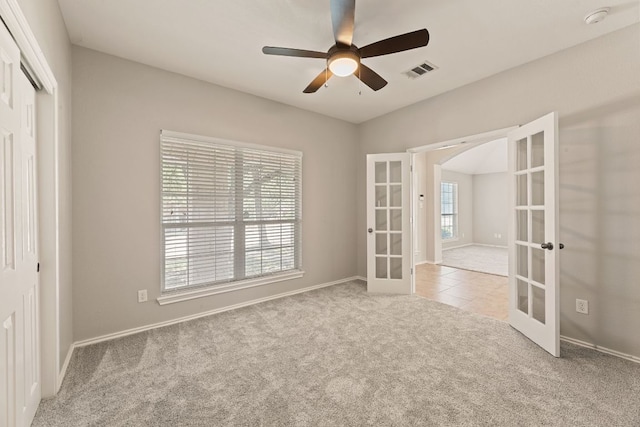 1129 Wigwam Dr, Leander, TX 78641 - empty room with french doors, carpet floors, a smoke detector, and ceiling fan