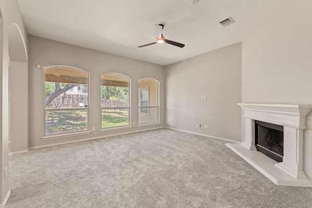1129 Wigwam Dr, Leander, TX 78641 - unfurnished living room featuring ceiling fan, carpet, and a fireplace with raised hearth