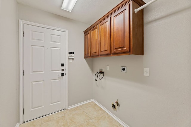 1129 Wigwam Dr, Leander, TX 78641 - laundry room with washer hookup, hookup for a gas dryer, electric dryer hookup, light tile patterned floors, and cabinet space