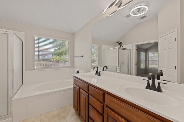 1129 Wigwam Dr, Leander, TX 78641 - bathroom featuring vaulted ceiling, a stall shower, plenty of natural light, a bath, and double vanity