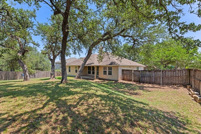 1129 Wigwam Dr, Leander, TX 78641 - back of property with a fenced backyard and a patio area