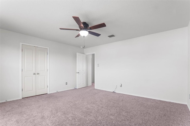 232 Wells Bnd, Hutto, TX 78634 - unfurnished bedroom with light colored carpet, baseboards, a closet, and a ceiling fan