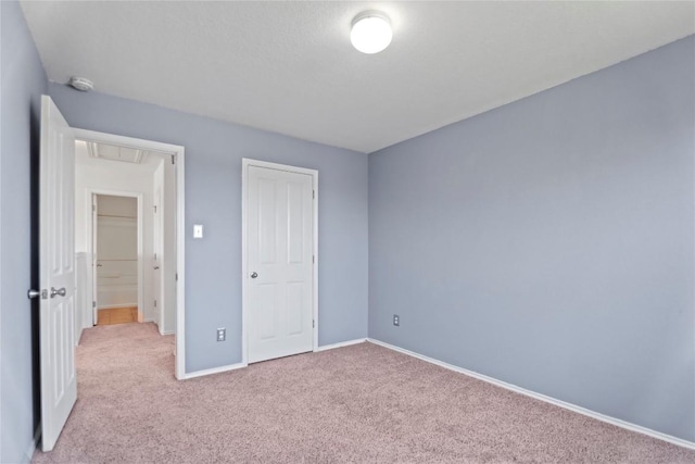 232 Wells Bnd, Hutto, TX 78634 - unfurnished bedroom featuring carpet, baseboards, and attic access