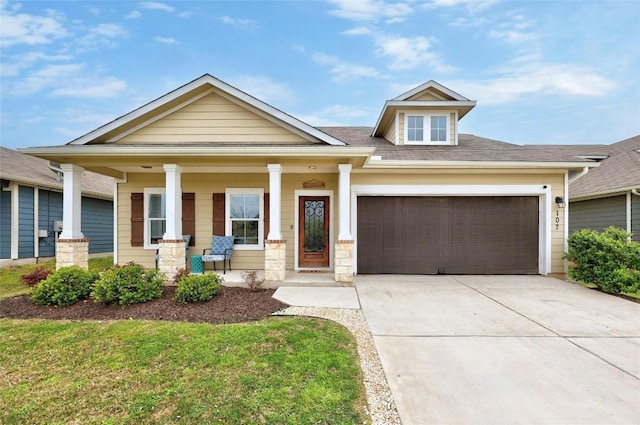 107 Denton Dr, Hutto, TX 78634 - craftsman-style house featuring an attached garage, driveway, and covered porch