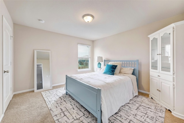 107 Denton Dr, Hutto, TX 78634 - bedroom featuring light carpet and baseboards