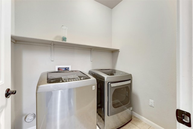 107 Denton Dr, Hutto, TX 78634 - laundry room with washer and clothes dryer and light tile patterned flooring