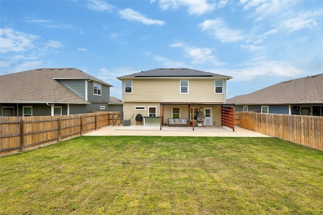107 Denton Dr, Hutto, TX 78634 - rear view of house with a patio, roof mounted solar panels, a fenced backyard, and an outdoor living space