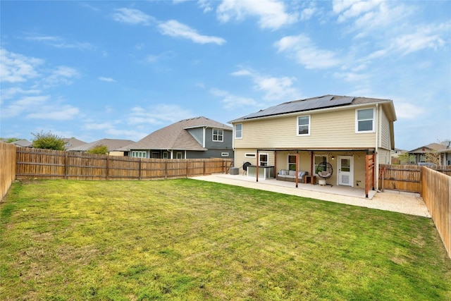107 Denton Dr, Hutto, TX 78634 - back of property with a patio area, roof mounted solar panels, and a fenced backyard
