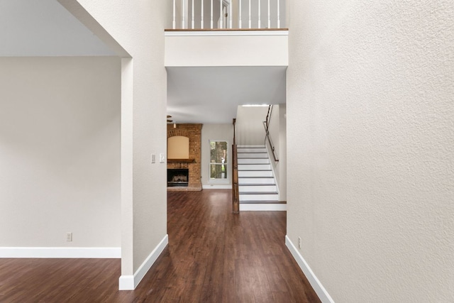 2308 Falcon Dr, Round Rock, TX 78681 - entryway with wood finished floors, stairs, baseboards, and a brick fireplace