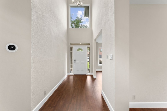2308 Falcon Dr, Round Rock, TX 78681 - entryway featuring a textured wall, dark wood-type flooring, a chandelier, and baseboards