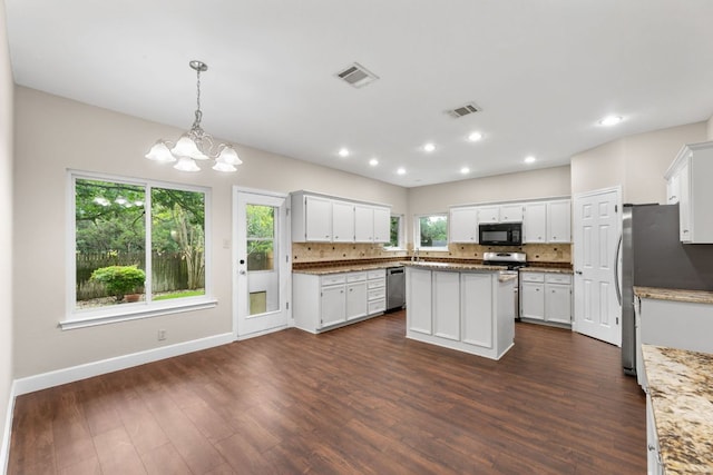 2308 Falcon Dr, Round Rock, TX 78681 - kitchen featuring appliances with stainless steel finishes, backsplash, dark wood-style flooring, a chandelier, and recessed lighting