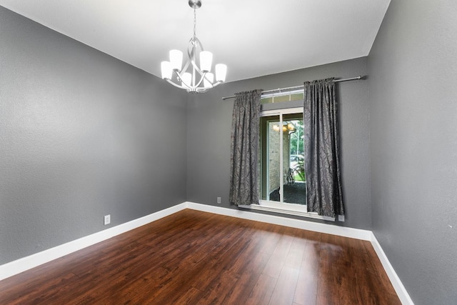2308 Falcon Dr, Round Rock, TX 78681 - unfurnished room with a chandelier, baseboards, and wood finished floors