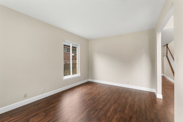 2308 Falcon Dr, Round Rock, TX 78681 - spare room featuring dark wood-style flooring, stairs, and baseboards