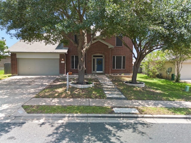 320 Ranier Ln, Round Rock, TX 78665 - view of property hidden behind natural elements with an attached garage, driveway, a front yard, and brick siding
