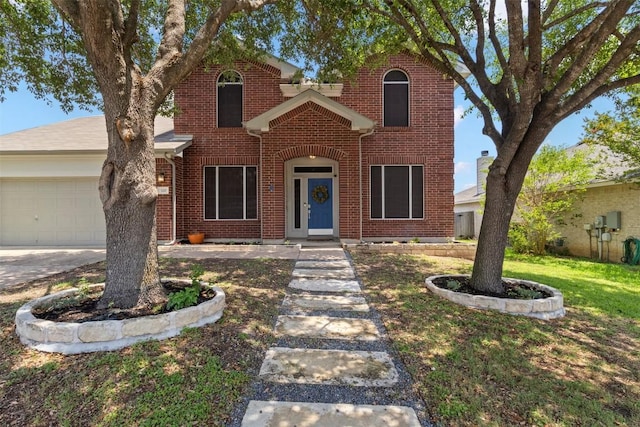 320 Ranier Ln, Round Rock, TX 78665 - traditional home with an attached garage, brick siding, and a front lawn