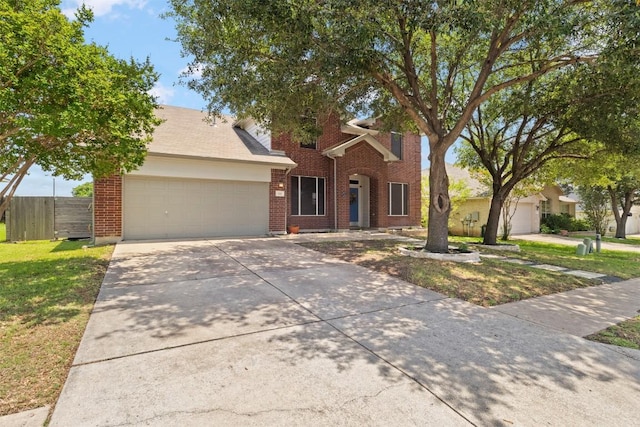 320 Ranier Ln, Round Rock, TX 78665 - traditional-style home featuring an attached garage, brick siding, and concrete driveway