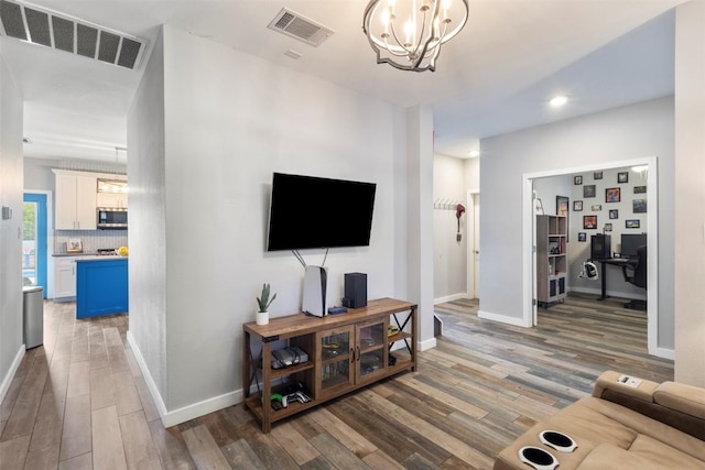 320 Ranier Ln, Round Rock, TX 78665 - living room featuring light wood-style flooring, an office area, a chandelier, baseboards, and recessed lighting