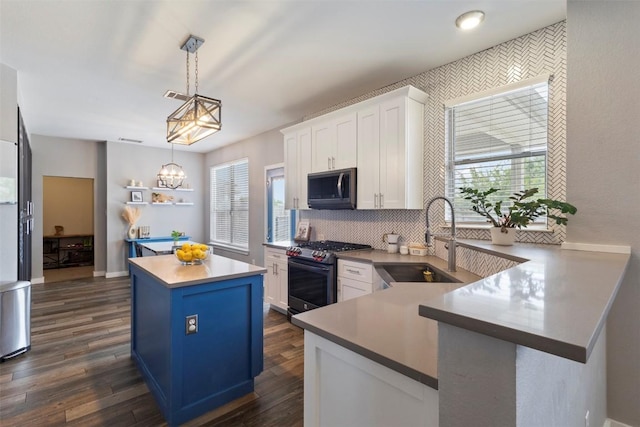 320 Ranier Ln, Round Rock, TX 78665 - kitchen featuring stainless steel appliances, a sink, a center island, white cabinets, and plenty of natural light