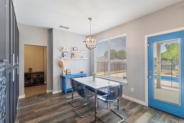 320 Ranier Ln, Round Rock, TX 78665 - dining room with a chandelier, healthy amount of natural light, dark wood-style flooring, and baseboards