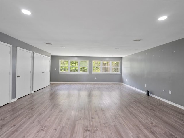 2939 Jeffcote Rd, Conroe, TX 77303 - unfurnished bedroom featuring baseboards, wood finished floors, recessed lighting, and multiple closets