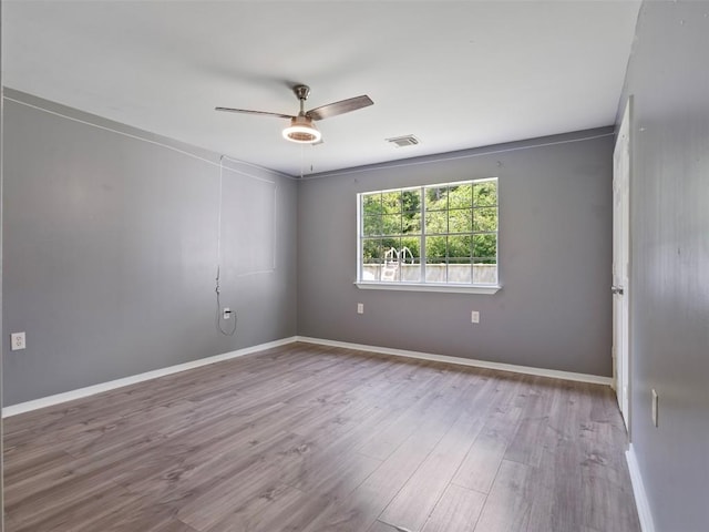2939 Jeffcote Rd, Conroe, TX 77303 - spare room featuring wood finished floors, ceiling fan, and baseboards