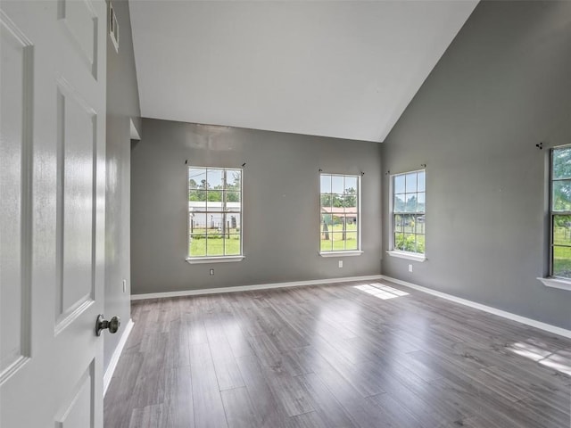 2939 Jeffcote Rd, Conroe, TX 77303 - unfurnished room featuring high vaulted ceiling, wood finished floors, and baseboards