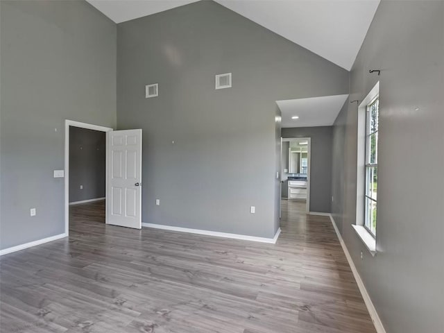 2939 Jeffcote Rd, Conroe, TX 77303 - empty room with high vaulted ceiling, baseboards, and wood finished floors