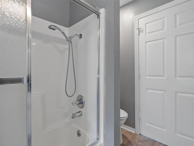 2939 Jeffcote Rd, Conroe, TX 77303 - bathroom with toilet, wood finished floors, bathing tub / shower combination, and baseboards