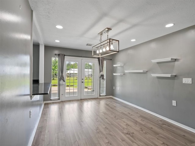 2939 Jeffcote Rd, Conroe, TX 77303 - unfurnished living room with baseboards, french doors, wood finished floors, a textured ceiling, and recessed lighting