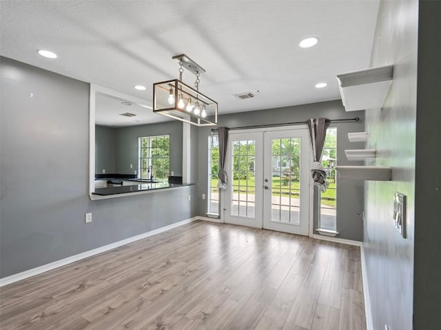 2939 Jeffcote Rd, Conroe, TX 77303 - unfurnished living room with french doors, baseboards, wood finished floors, and recessed lighting