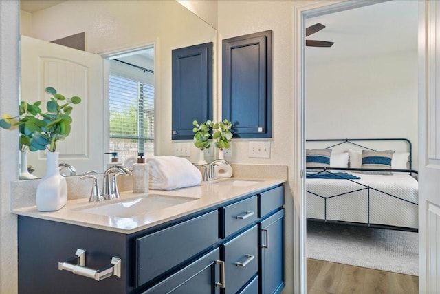 16513 Brogan Ln, Pflugerville, TX 78660 - ensuite bathroom featuring double vanity and wood finished floors