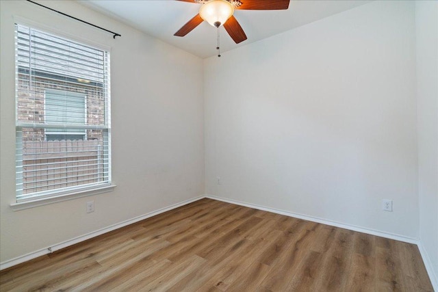 16513 Brogan Ln, Pflugerville, TX 78660 - empty room featuring wood finished floors, a ceiling fan, and baseboards