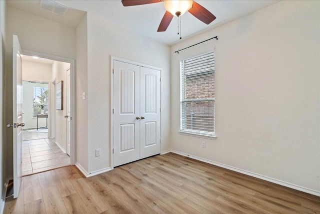 16513 Brogan Ln, Pflugerville, TX 78660 - unfurnished bedroom featuring light wood-type flooring, a closet, baseboards, and ceiling fan