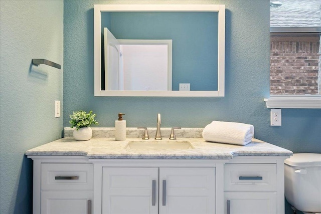 16513 Brogan Ln, Pflugerville, TX 78660 - bathroom with vanity, toilet, and a textured wall