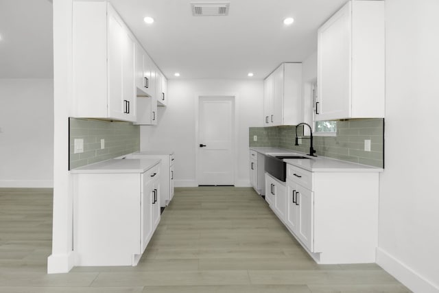 1509 Parkview Ln, San Marcos, TX 78666 - kitchen featuring a sink, baseboards, light countertops, decorative backsplash, and recessed lighting