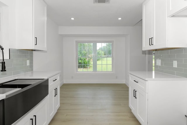 1509 Parkview Ln, San Marcos, TX 78666 - kitchen with baseboards, light countertops, white cabinetry, and recessed lighting
