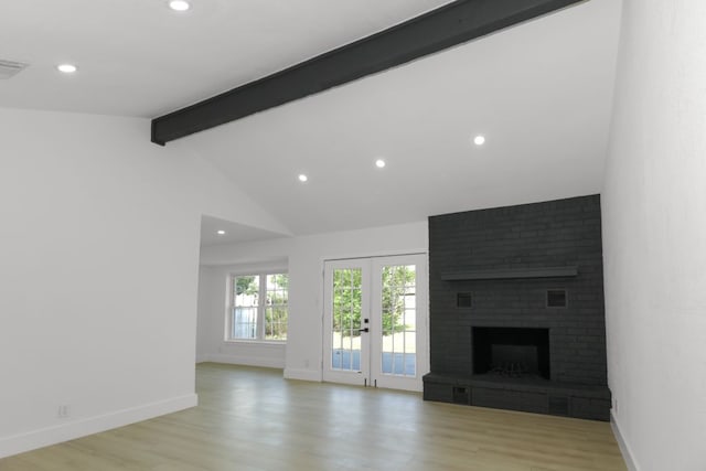 1509 Parkview Ln, San Marcos, TX 78666 - unfurnished living room with beamed ceiling, french doors, light wood-style floors, recessed lighting, and a brick fireplace