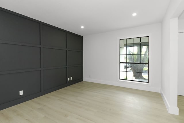 1509 Parkview Ln, San Marcos, TX 78666 - unfurnished bedroom with light wood-type flooring, baseboards, recessed lighting, and a decorative wall