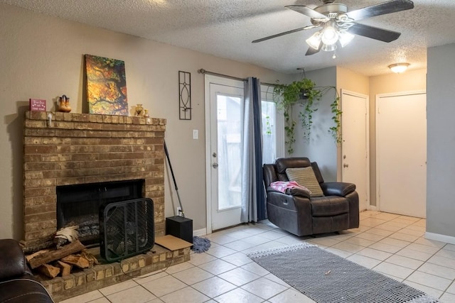 2625 Gwendolyn Ln, Austin, TX 78748 - living area featuring plenty of natural light, light tile patterned flooring, a textured ceiling, a fireplace, and a ceiling fan