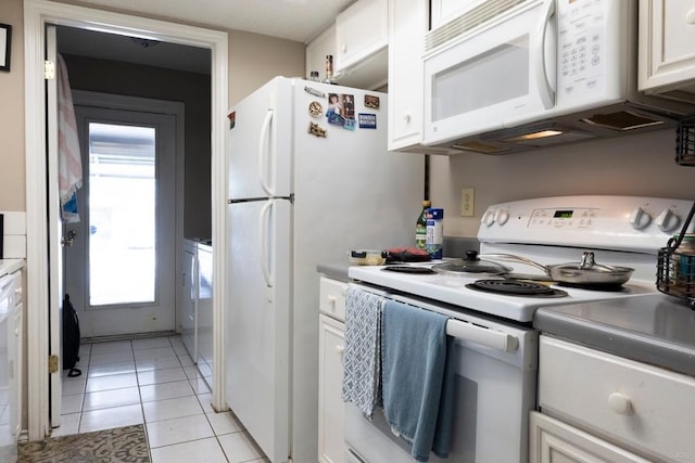 2625 Gwendolyn Ln, Austin, TX 78748 - kitchen with white appliances, white cabinets, light tile patterned floors, and light countertops