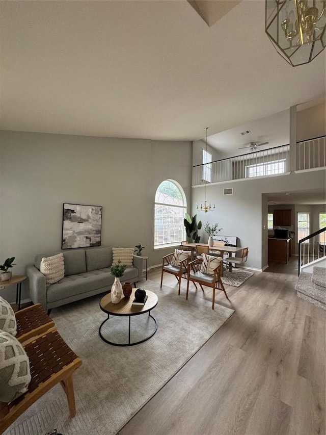 10301 Beard Ave, Austin, TX 78748 - living area with wood finished floors, a chandelier, stairs, and baseboards