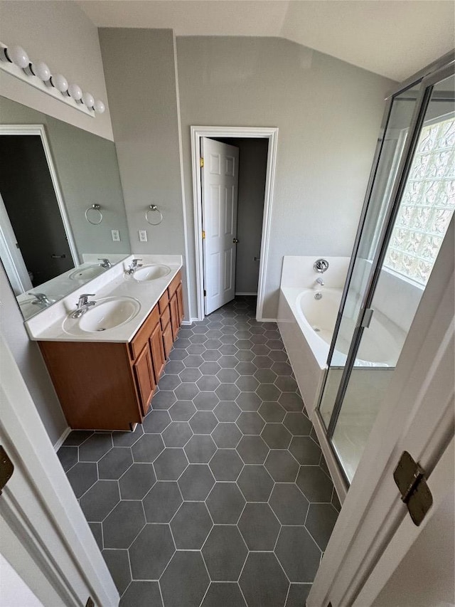 10301 Beard Ave, Austin, TX 78748 - bathroom featuring a garden tub, double vanity, a shower stall, tile patterned flooring, and lofted ceiling
