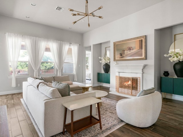 116 Waterloo Cv, Georgetown, TX 78628 - living area with wood finished floors, recessed lighting, baseboards, a chandelier, and a lit fireplace